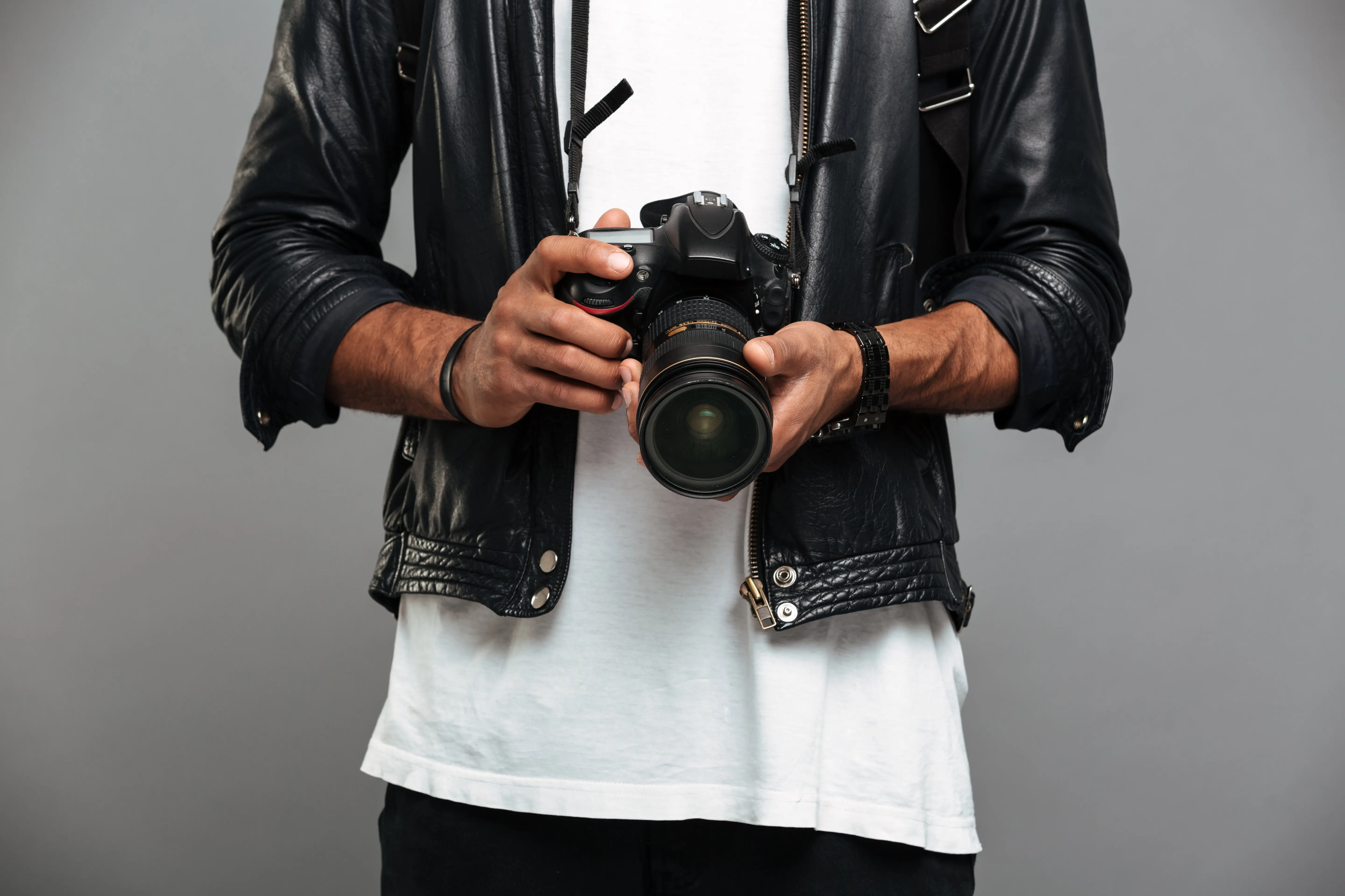 stylish-afro-american-guy-holding-digital-camera-min