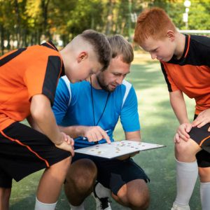 Sports – Football Trainer Teaching His