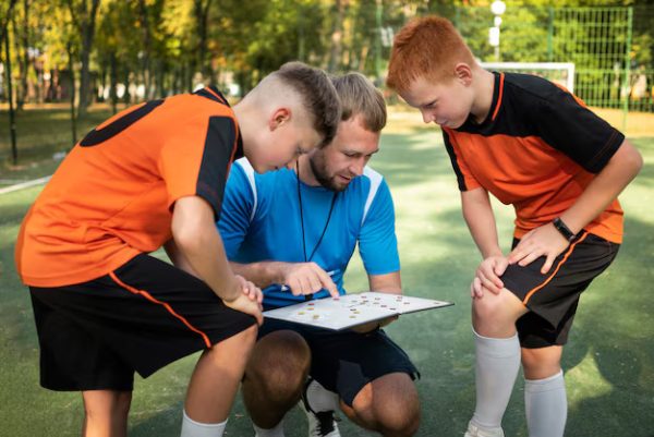 Sports – Football Trainer Teaching His